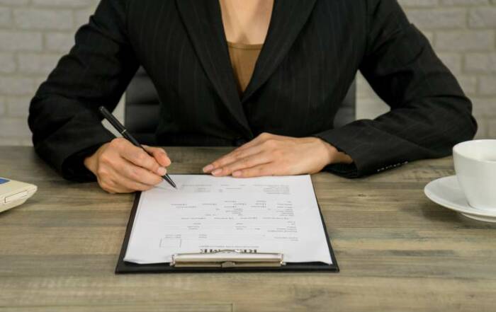business woman write resume for applying the job